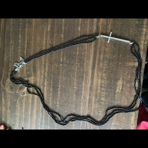Long black beaded cross necklace